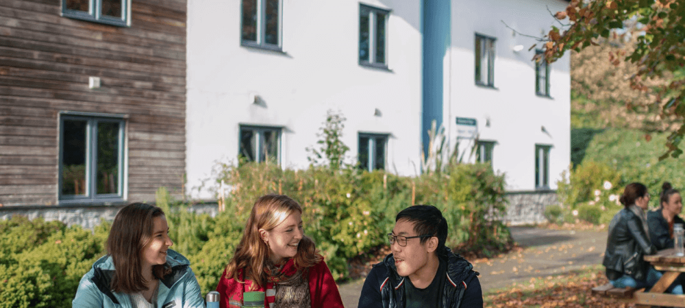 Students sat outside Penryn Campus accommodation.