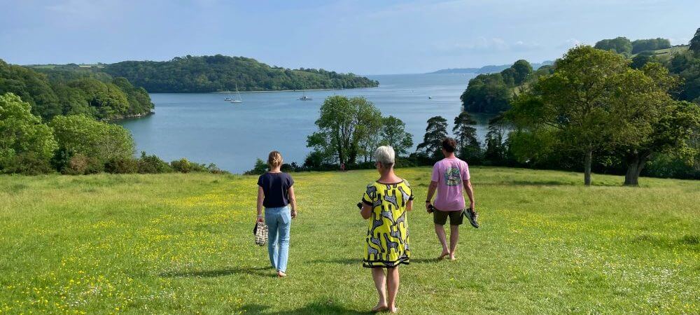 Language Tree staff and students walk barefoot on the grass, Trelissick.
