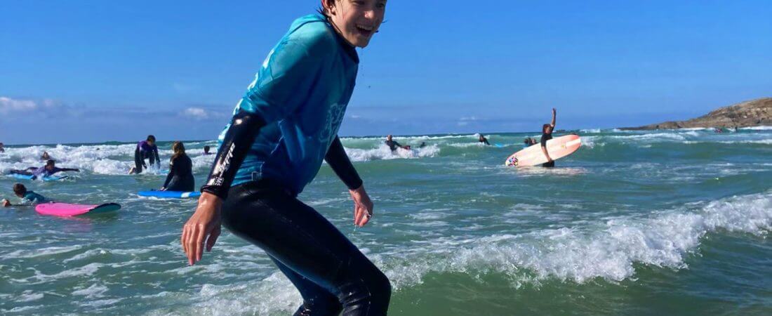 Junior Summer School student loving his surf lessons.