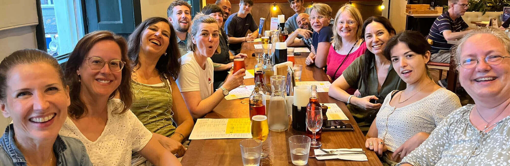 Language Tree staff and adult students enjoying drinks in a pub, Falmouth.