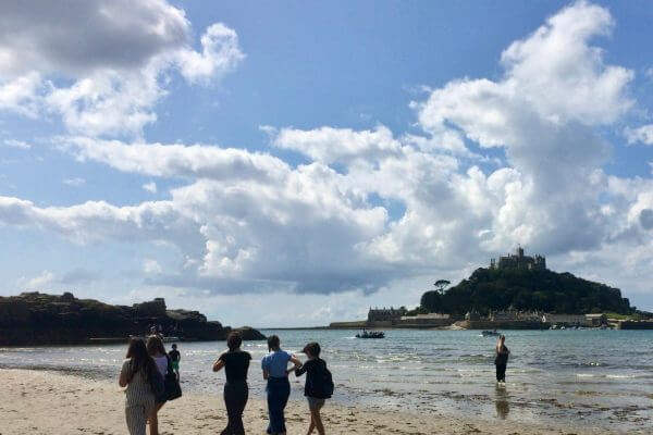 Language Tree students walking on the beach to St Michael's Mount.