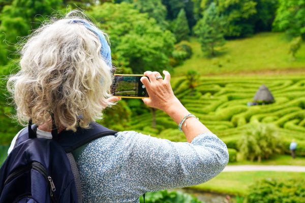 Language Tree student taking a photo at Glendurgan Gardens