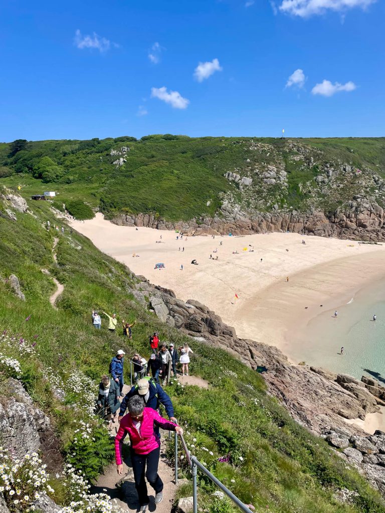 Language Tree walking group enjoying the South West Coast Path at Porthcurno
