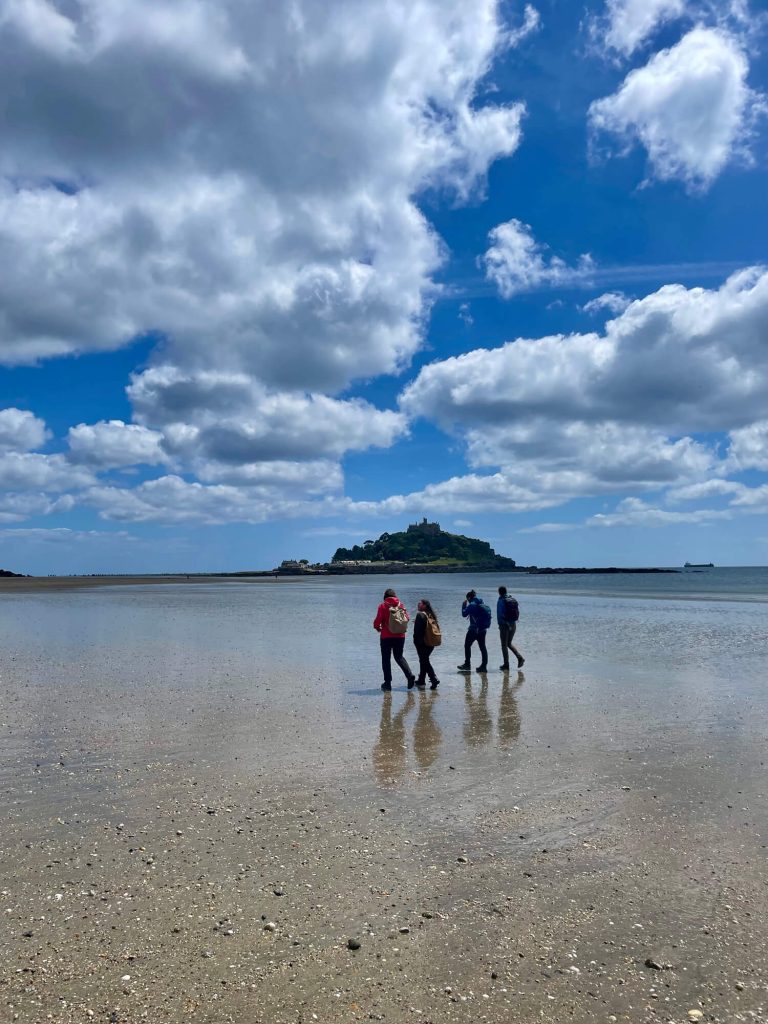 Students walking along the beach to St Michael's Mount.